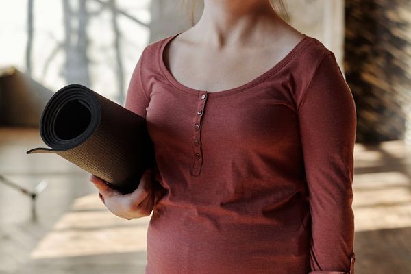 A bright and airy room with a yoga mat ready for practice.