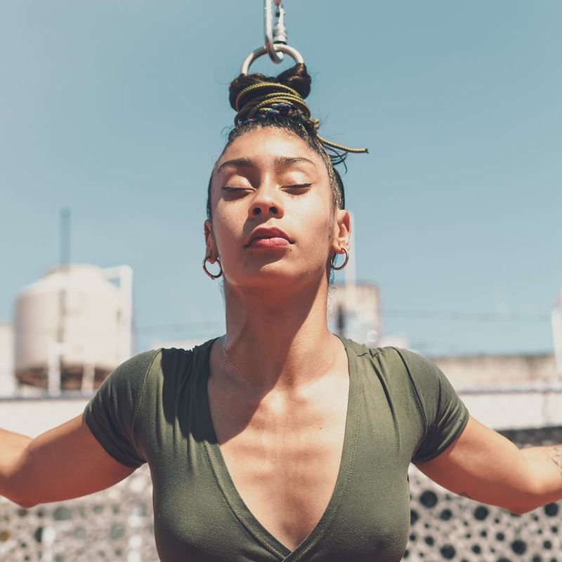 Woman performing a focused, graceful yoga pose.
